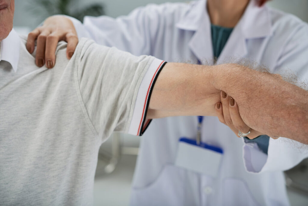 Inaptitude après acromioplastie : vos droits et démarches 2 Médecin du travail examinant la mobilité du bras d'un salarié après une chirurgie de l'épaule.